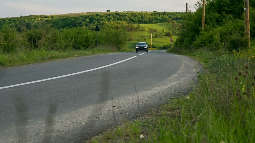 Black luxury car in springtime.