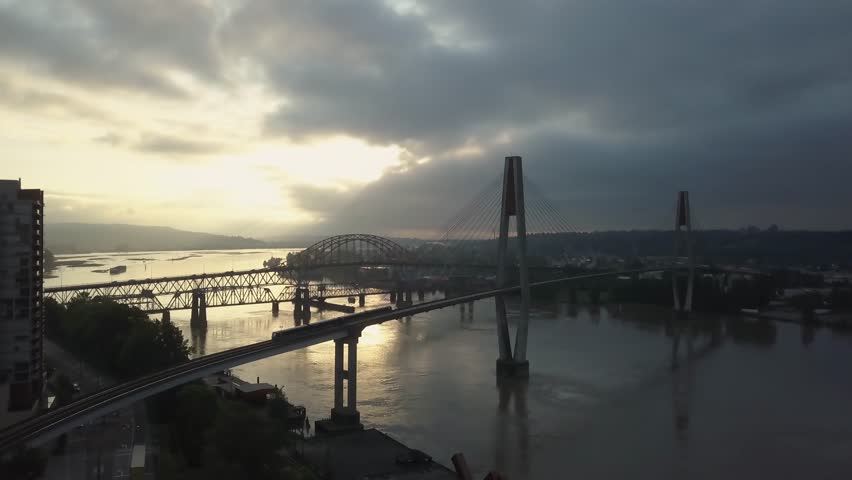 Aerial view of Fraser River and Bridges during a vibrant sunrise. Taken in New Westminster, Greater Vancouver, British Columbia, Canada.