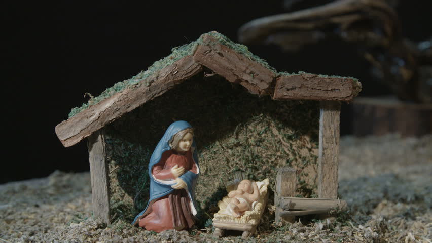 Nativity scene with baby Jesus, Virgin Mary and the innocent lamb.