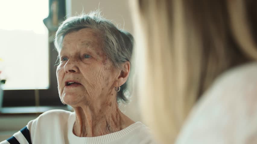 Elderly grandmother with an adult granddaughter talking at home. | Shutterstock HD Video #1012224119