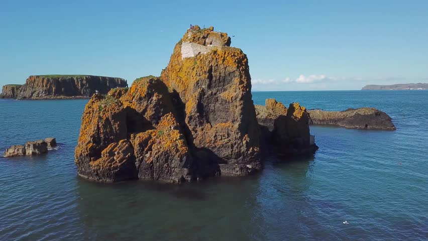 4k aerial footage of cliff in ocean with birds in Ireland