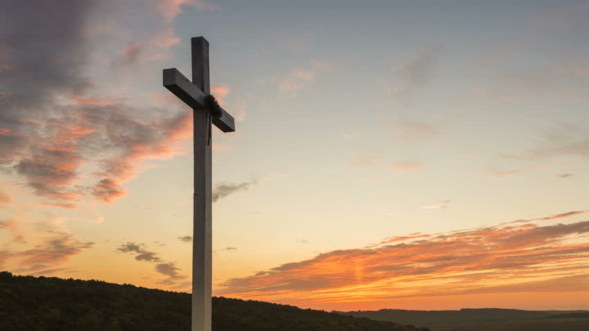 Cross on the hill at sunset - zoom out