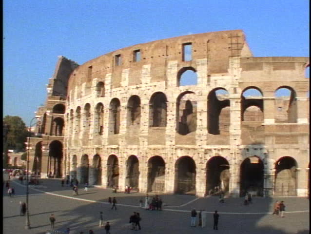 ITALY, 1999, Rome, the Coliseum, pan left, people, shot high looking down