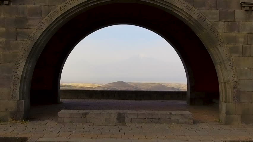 Famous Mount Ararat under sky clouds, view through Arch of Charents, Armenia