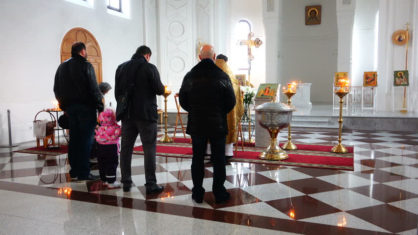 sinful people in the church pray and pray for sins before the icons.