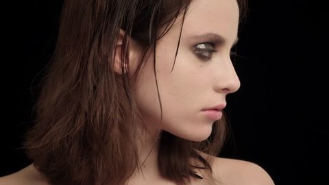  sensual young brunette woman with smokey cream eyeshadow video portrait on black background