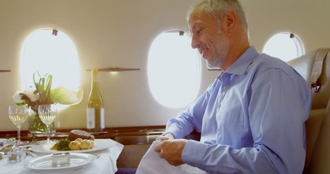 Businessmen having meal in private jet 4k