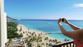 Professional video of woman taking picture of Waikiki beach in Hawaii in 4K slow motion 60fps
