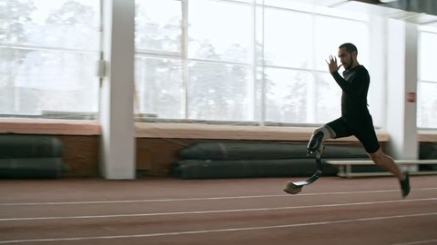 Tracking of determined sportsman with prosthetic leg sprinting on indoor track during practice