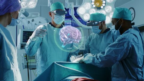 Surgeons Wearing Augmented Reality Glasses Perform Brain Surgery with Help of Animated 3D Brain Model, Using Gestures. High Tech Technologically Advanced Hospital.  Shot on RED EPIC-W 8K Helium Camera
