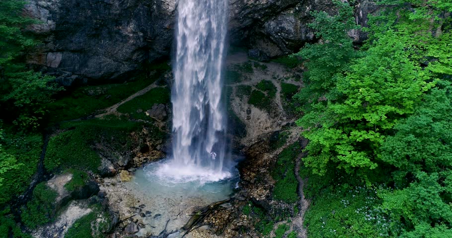 European man with beard is doing waterfall-meditation while standing under big waterfall in austria, wildensteiner waterfall | Shutterstock HD Video #1012267043