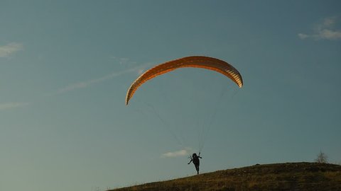 Silhouette Man Paragliding Beautiful Summer Sunset Sky. Paraglide flight experience skydive summer