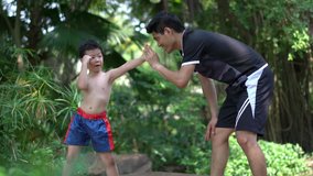 Asian little chinese boy study thai boxing with coacher. concept of sport exercise.