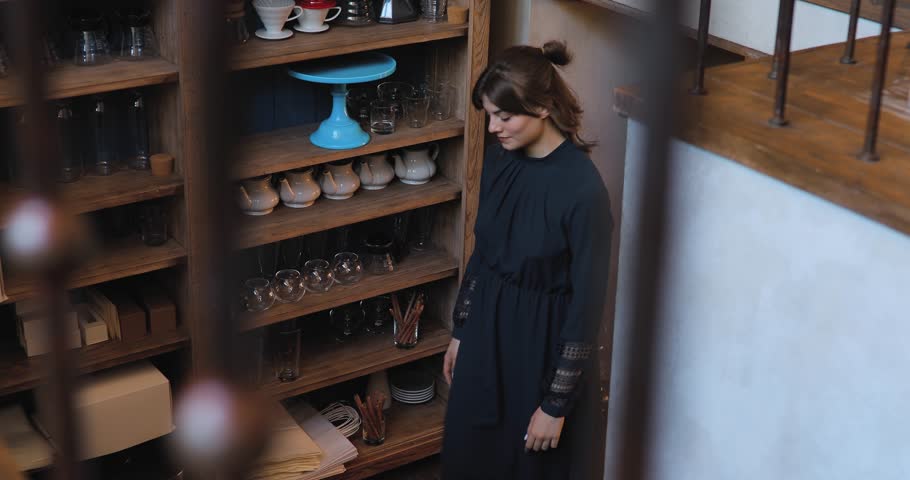Young girl go up on stairs in a cafe