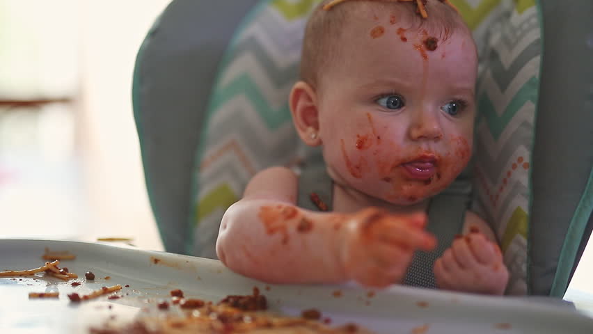 Little baby eating her dinner and making a mess | Shutterstock HD Video #1012276031