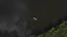 Aerial View of fishermen swim by boat on the lake