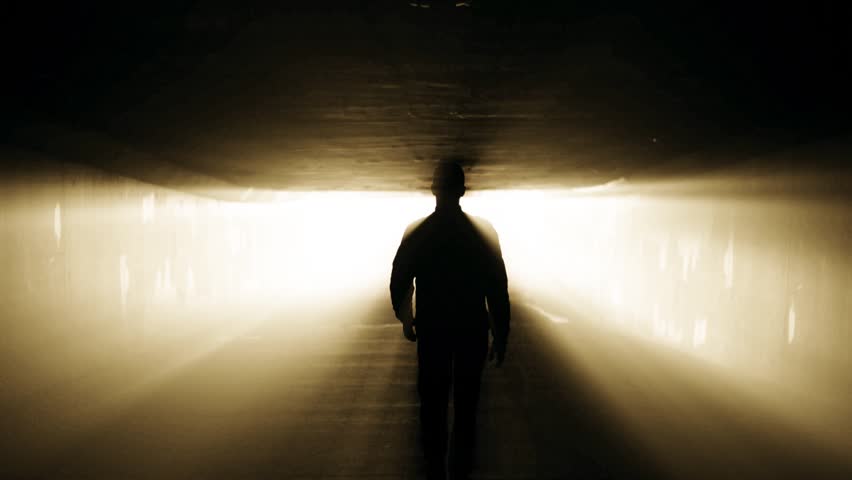 Walk in tunnel to the light. Afterlife concept in slow motion.