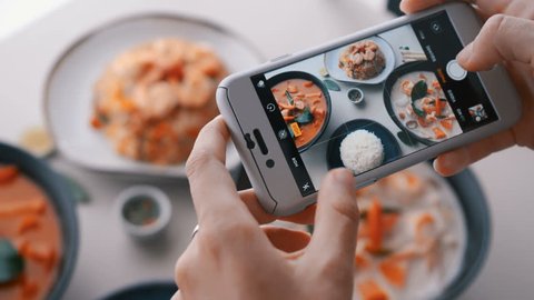 Female hands take photos of food by modern smartphone. Closeup. 4K.