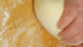 Baker kneading dough on table in flour. Closeup shot of domestic home made and handmade diy bakery. Vertical format video.