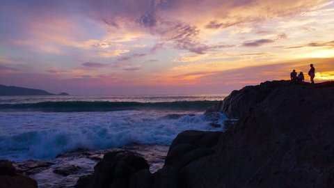 
Sunset over the sea coast. And high waves impact amazing rock formations at Patong Phuket Thailand.
