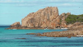 Castle Rock, near Dunsborough in Western Australia, is a massive chunk of orange granite standing tall at the end of beautiful Castle Bay.