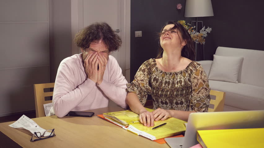 Couple at home crying for financial problems slow motion