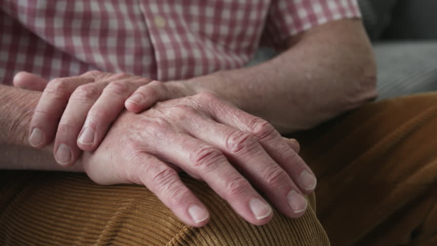 Man Suffering With Parkinsons Disease Holding Trembling Hand | Shutterstock HD Video #1012307237