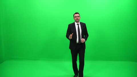 Businessman Presenting By A Hand On A Green Screen