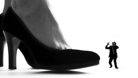 Female leg in high heels crushing small man, womens domination, silhouette