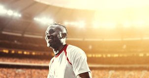 Soccer player celebrates a victory and raises arms happily on the professional stadium while the sun shines. Stadium and crowd are made in 3D and animated.