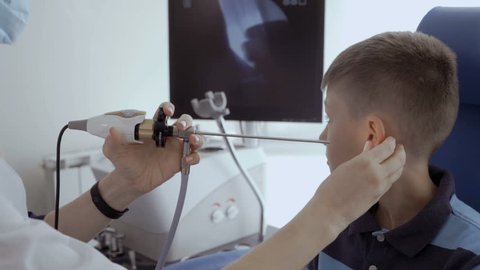 Doctor check ear of child with ENT telescope