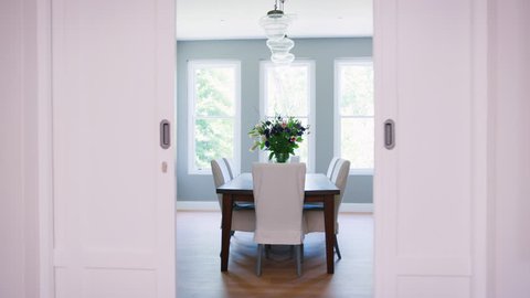 Sliding doors opening onto furnished domestic dining room