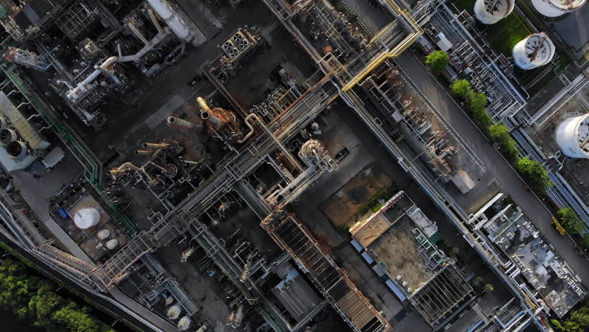 Aerial top down view over oil refinery or chemical factory and power plant with many storage tanks and pipelines. Shot with 4K UHD resolution drone. | Shutterstock HD Video #1012324229