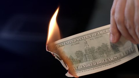 Male hand burning dollar banknote. Man burning money cash. Financial crisis and depressed economy. Paper money loss concept. Fire money concept