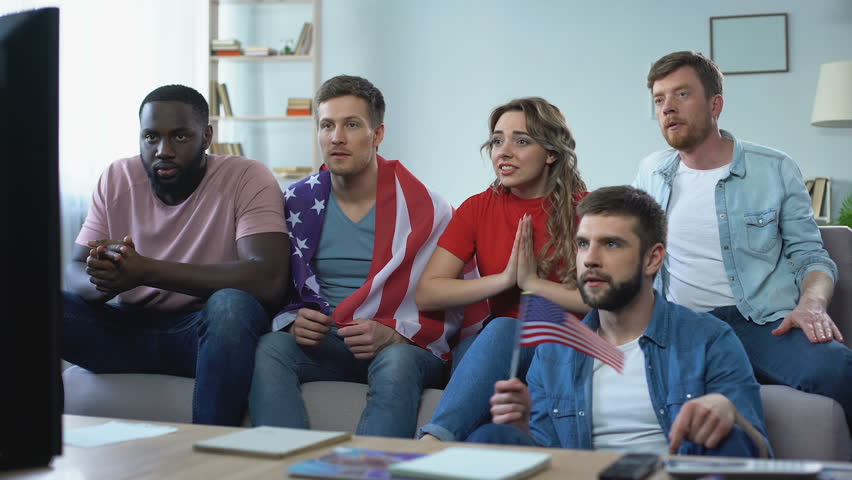 Multiracial American fans watching match on TV at home, celebrating team goal | Shutterstock HD Video #1012331015