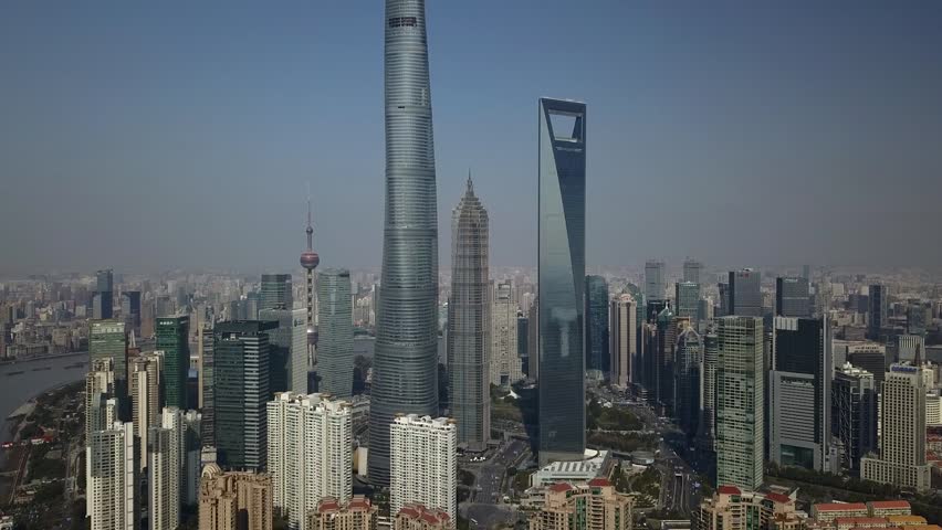 Helicopter High altitude Shanghai China Pudong Skyscraper Mao Pearl Tower World Financial business Center Modern glass active trade movement energy Road traffic Travel attraction. Summer Unique Aerial