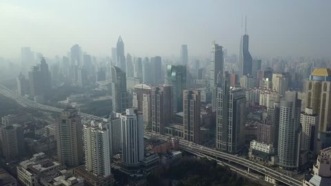 Helicopter typical Shanghai China modern cityscape Skyscrapers glass steel city Busy street traffic car Elevated overpass urban Financial business Technology futuristic fog smoke. Aerial Approach 4k
