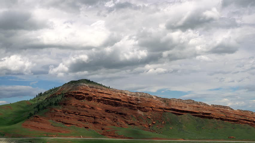 Time lapse of clouds moving over red dirt hillside in Wyoming from on Dead Indian Hill Road.