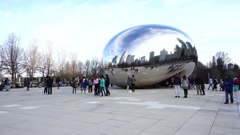 CHICAGO, ILLINOIS (USA) - April 22,2018 : Crowded of people visiting the Cloud Gate sculpture in Millennium Park, Chicago,USA on April 22,2018. It is also known as the Bean.