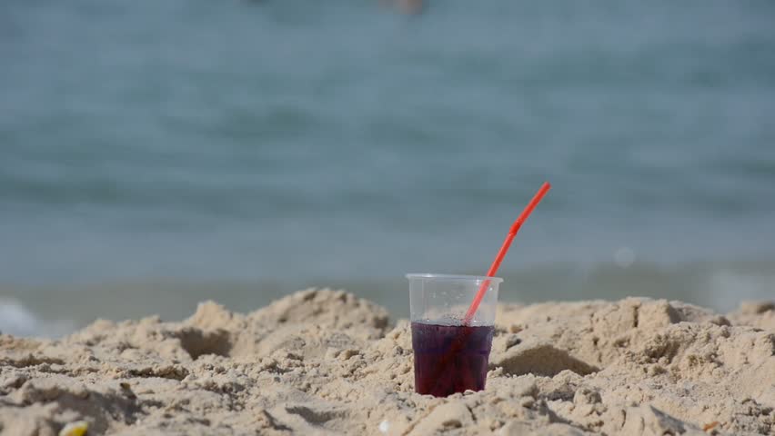 Refreshing Cold Soft Drink in Sand on Beach