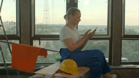 Young relaxed female engineer using cell phone or texting o break - Powered by Shutterstock - Get 15% off with code: PIKWIZARD15