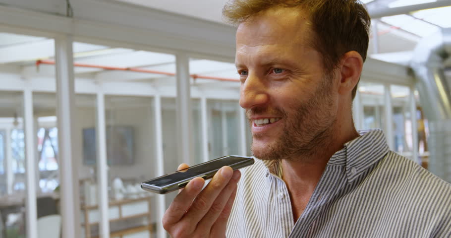 Male executive talking on mobile phone in office 4k