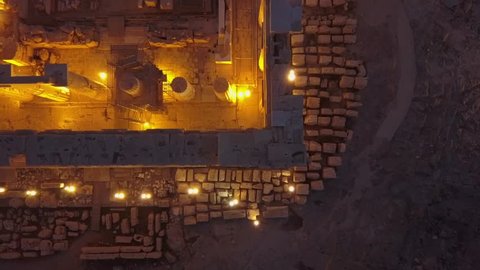 Overhead 4k drone shot of Athens Acropolis Parthenon. Illuminated at night. Aerial of famous temple 