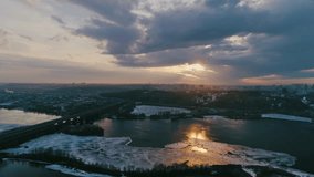 High angle view. The camera descends above The Dnipro River at sunset. Aerial footage. Winter. 4K