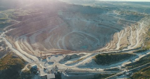 Aerial view of opencast mining quarry with lots of machinery at work - view from above.