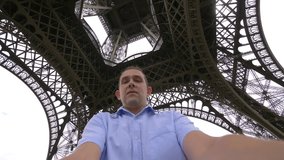 
Professional video of happy man spinning and having fun under the Eiffel tower in Paris in 4k slow motion 60fps