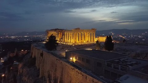 Athens Acropolis and Parthenon in evening at sunset. beautifully lit up. Aerial 4k drone view from above the Greek capital. City center in background. 4k view in low light. 