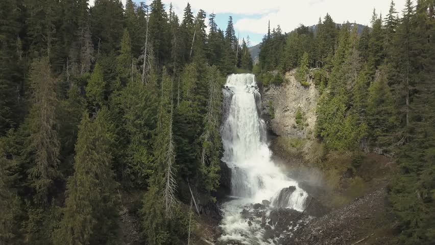 Aerial view of the beautiful waterfall, Alexander Falls, during a sunny summer day. Located near Squamish and Whistler, North of Vancouver, British Columbia, Canada.