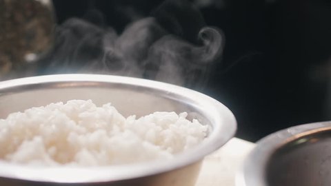 Close up slow motion shot of hot steam rice