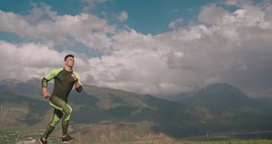 young confident man jogging in mountains in morning 4k
